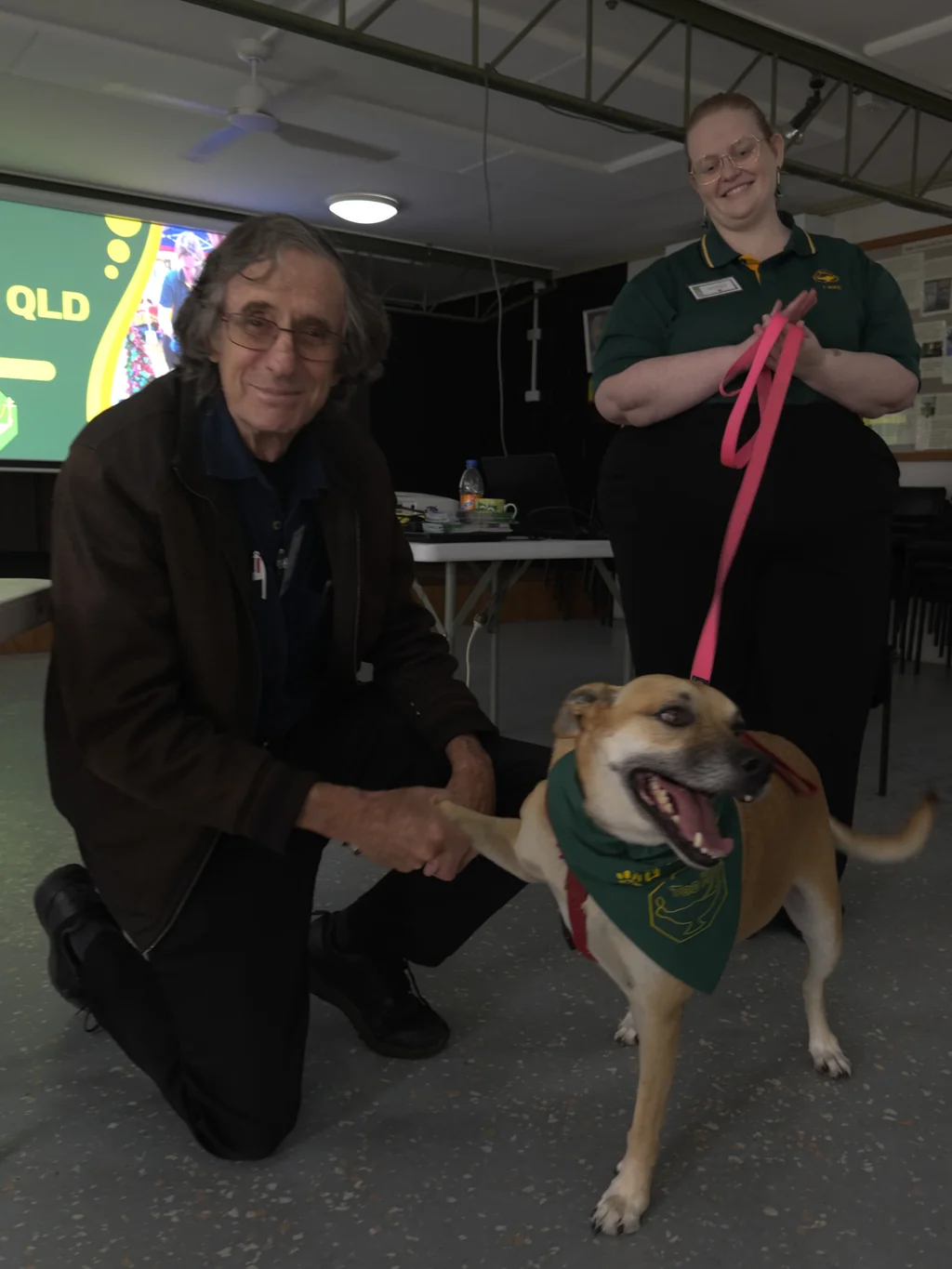 Nelly the dog shaking paws as she is officially elected as Brisbane Branch mascot