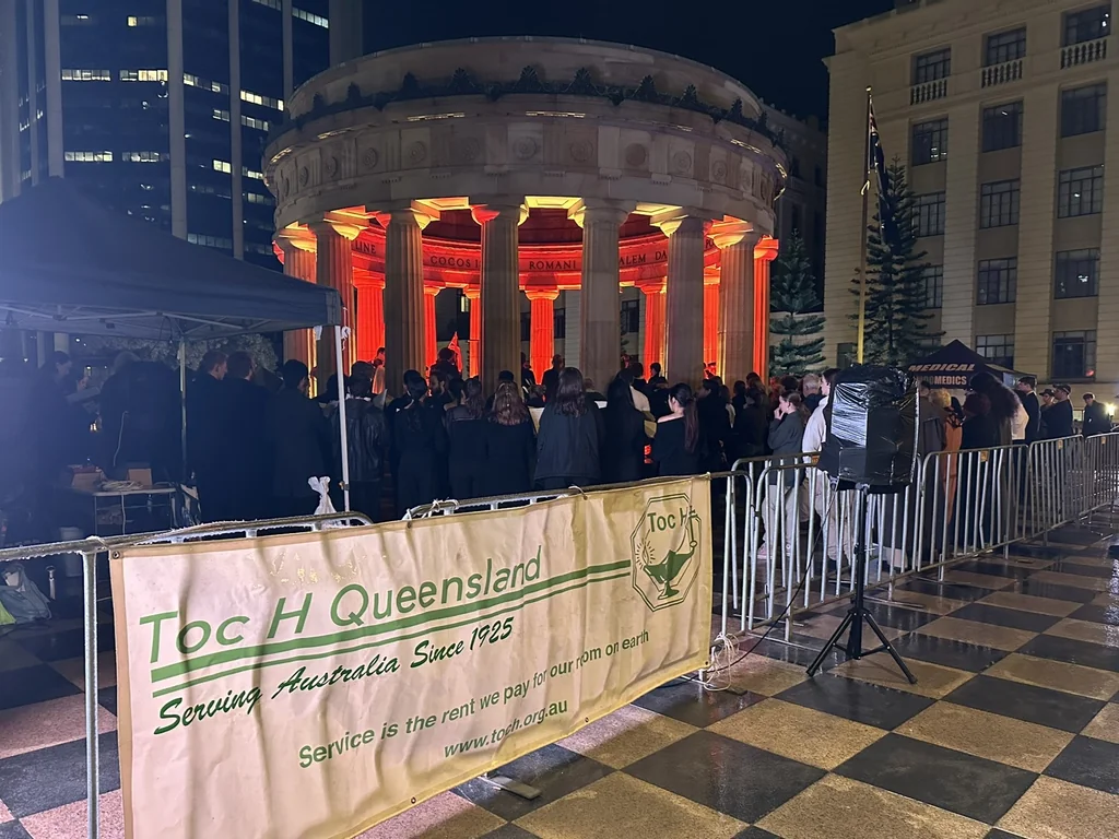 Toc H Queensland banner with the Shrine of Remembrance and crowd behind, ANZAC Eve 2026