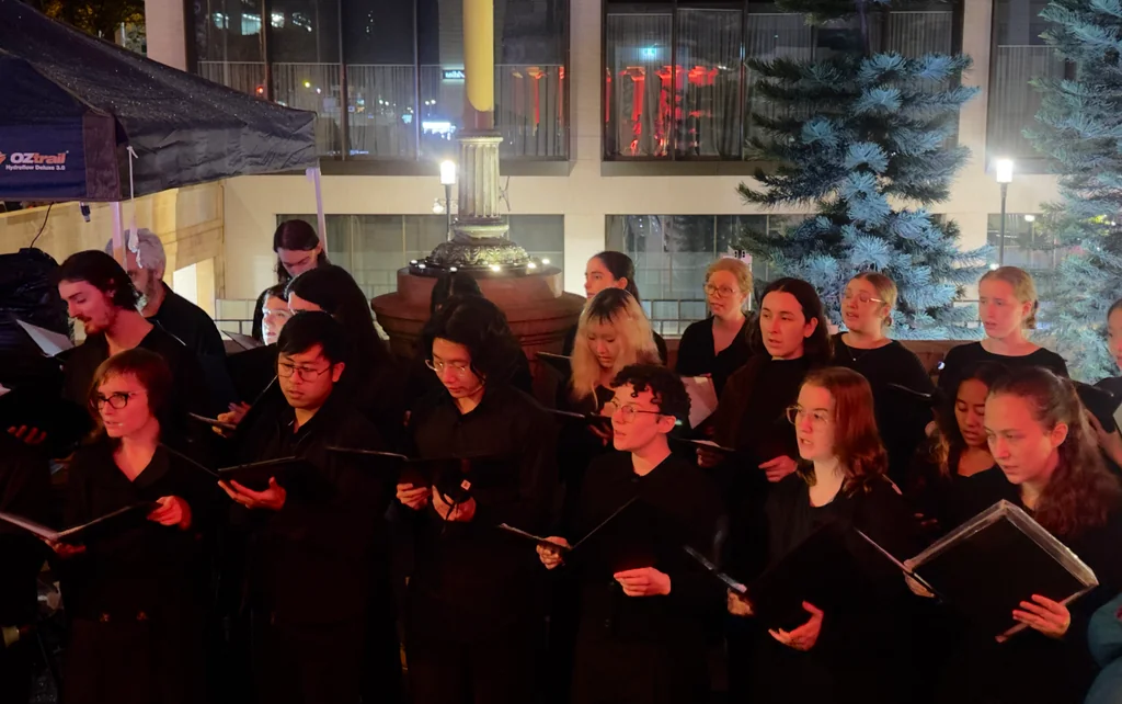 QUMS choir singing at the 2026 ANZAC Midnight Service
