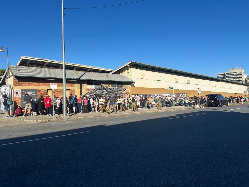 Families and volunteers waiting outside the Brisbane Showgrounds for the Toc H Queensland Ekka Outing