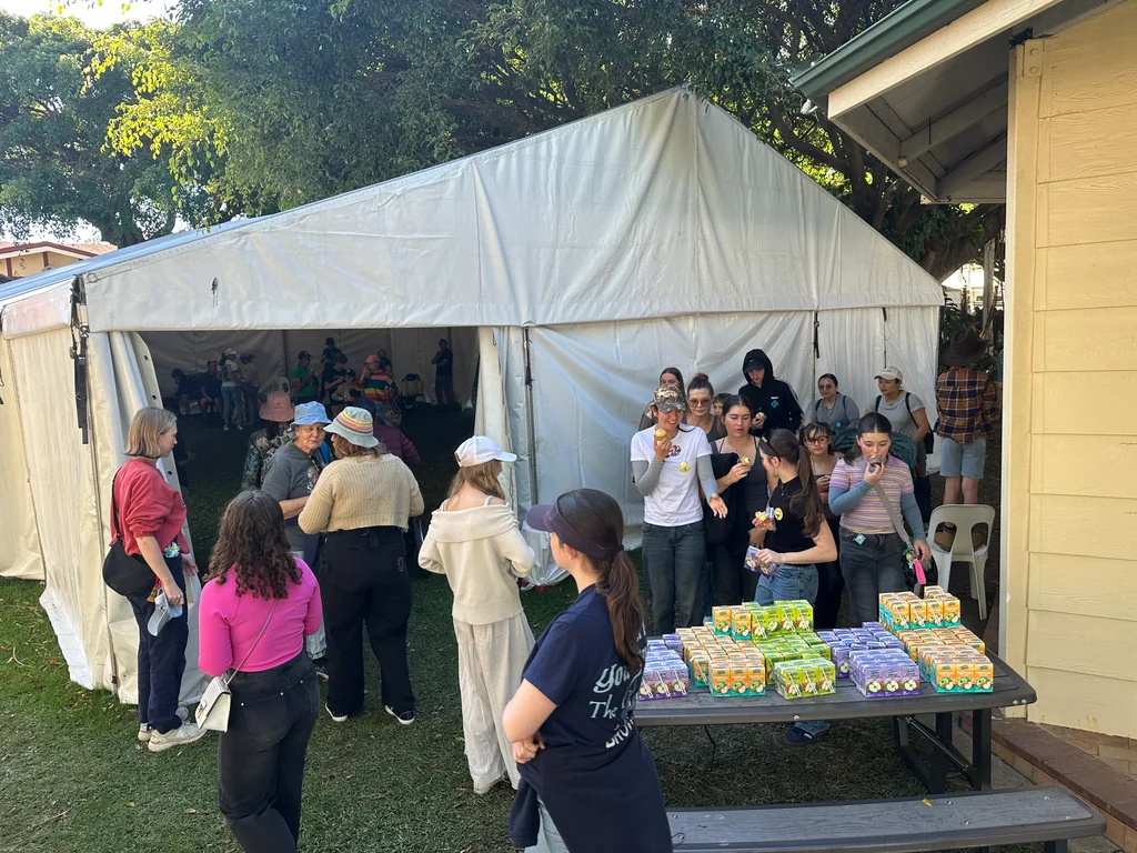 Families collecting juice boxes and show bags at the Toc H Queensland Ekka Outing