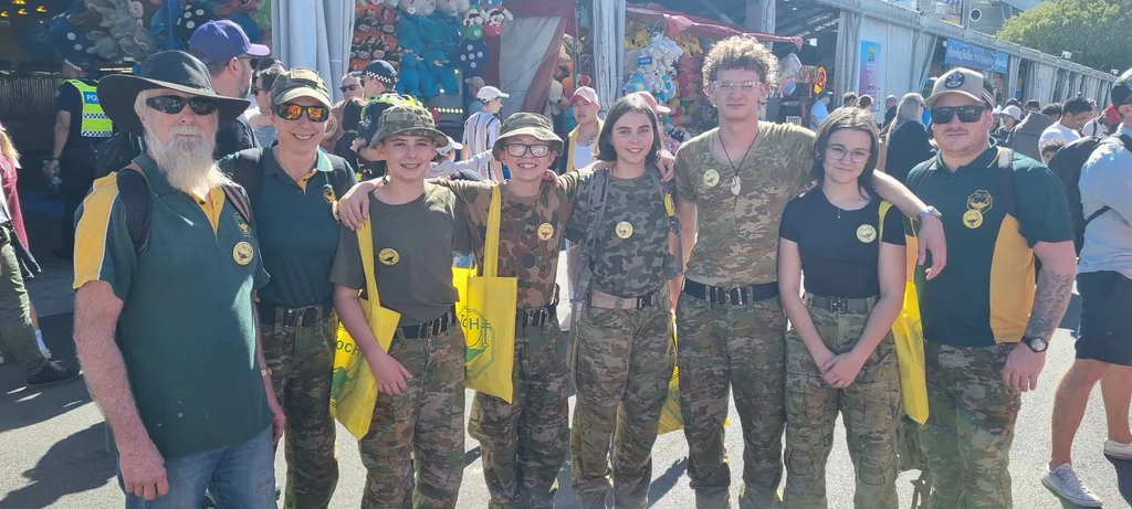 Scenic Rim Cadets with Toc H Queensland volunteers holding yellow Toc H show bags at the Ekka