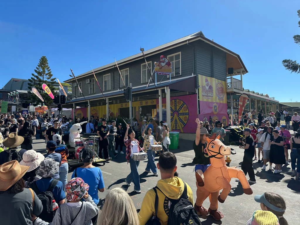 A roaming band performing at the Ekka, crowds gathered to watch