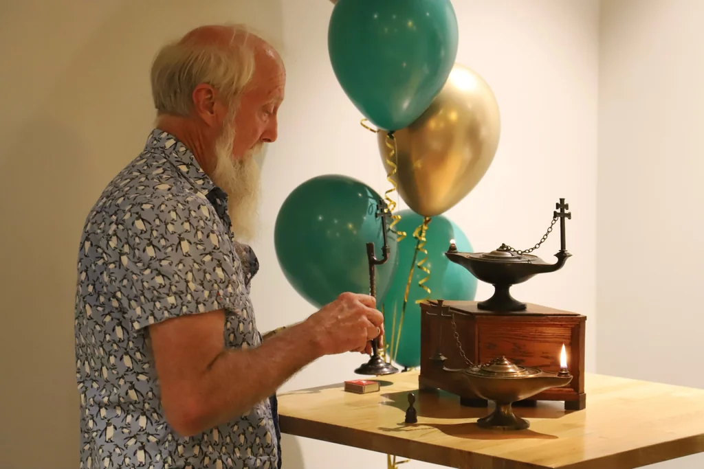 Lighting the Toc H lamp at the World Chain of Light, Queensland 2025