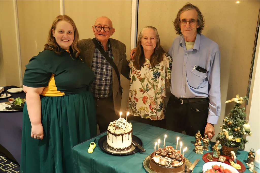 Laura, Ray, Flora and Owen gathered around the 100th anniversary cake